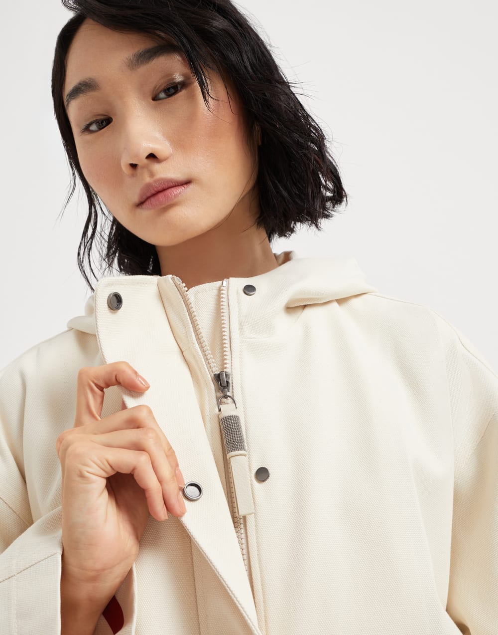 Water-resistant cotton canvas hooded outerwear jacket with heat-bonded seams and shiny zipper pull
